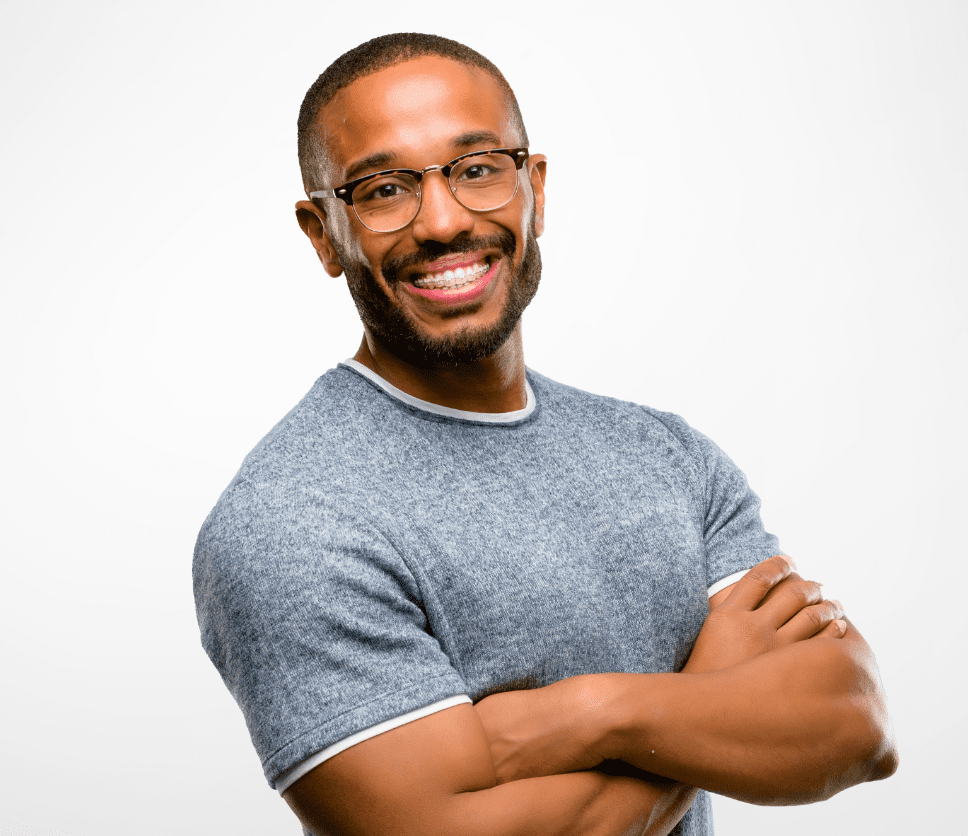 Adult man wearing glasses, crossing his arms and smiling.