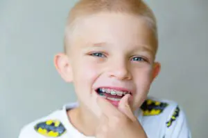 Portrait of a blond 8 year old boy with braces