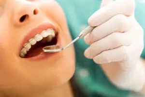 Dentist checking on woman's braces