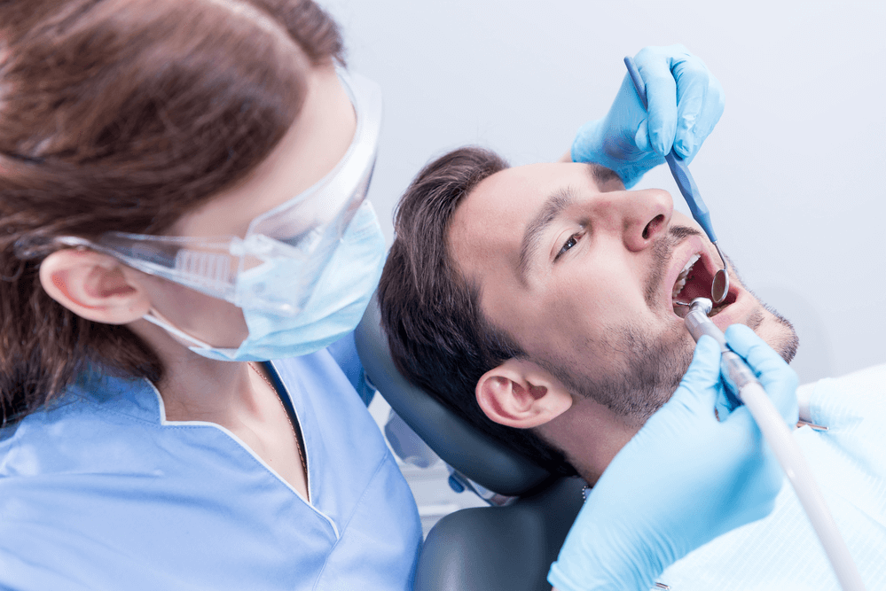 Professional dentist working with patient