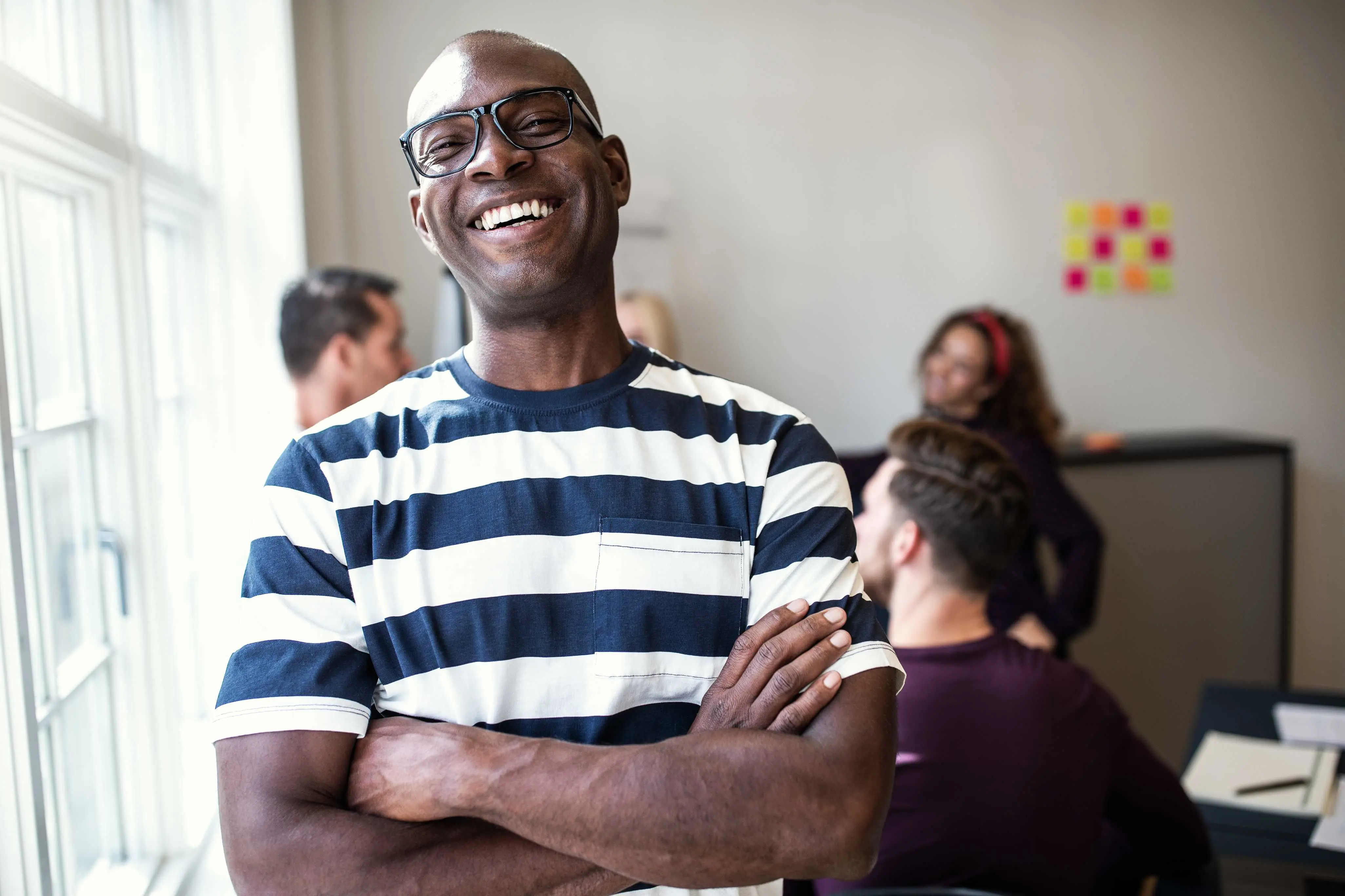 man standing in office smiling