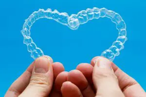 holding clear aligners in a heart shape