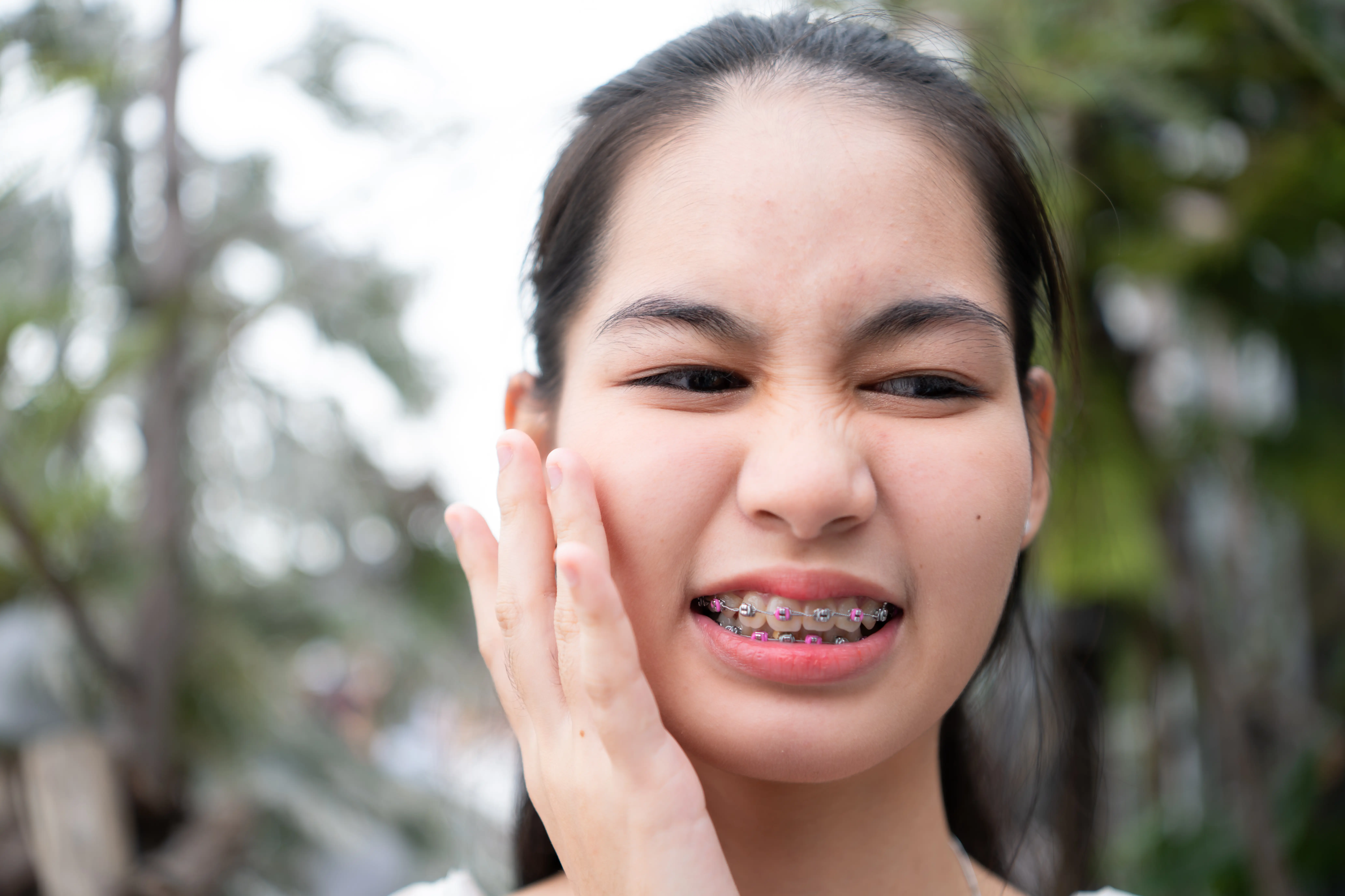 Portrait of a young asian woman with braces on her teeth