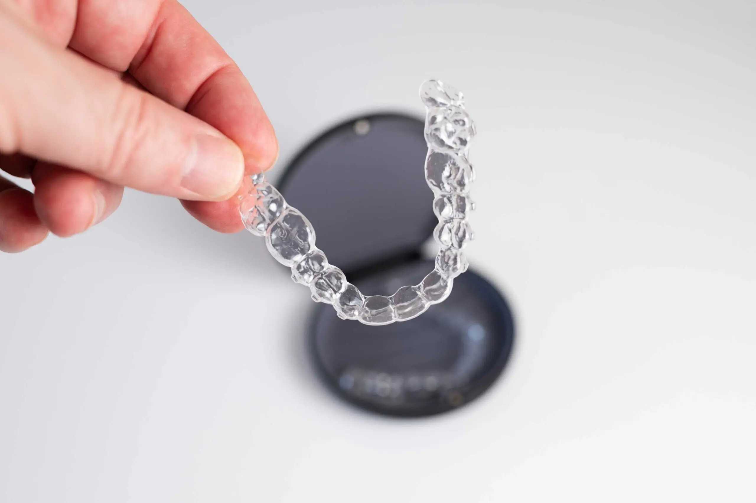 dentist holding a retainer