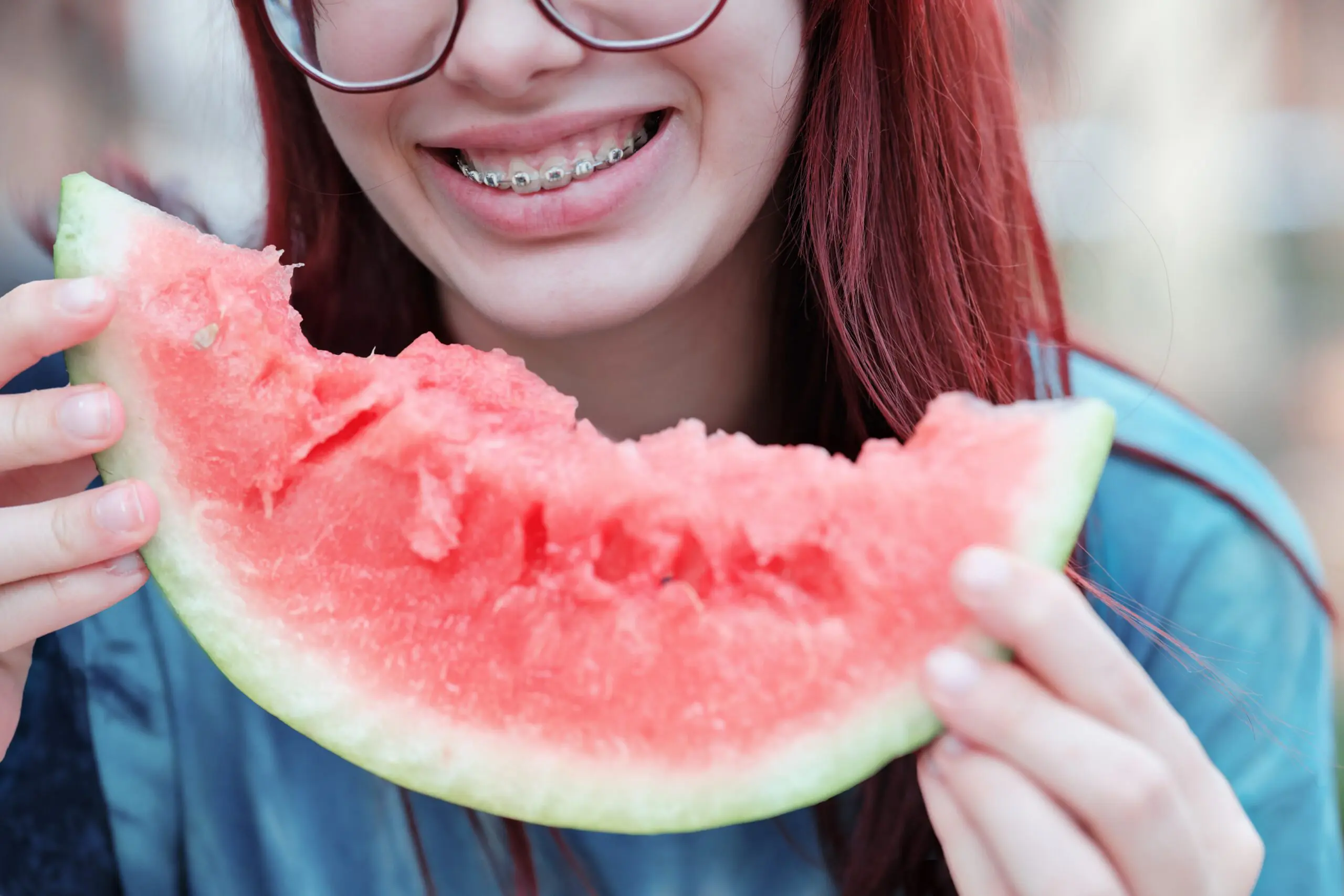 girl eating a slice of watermelon