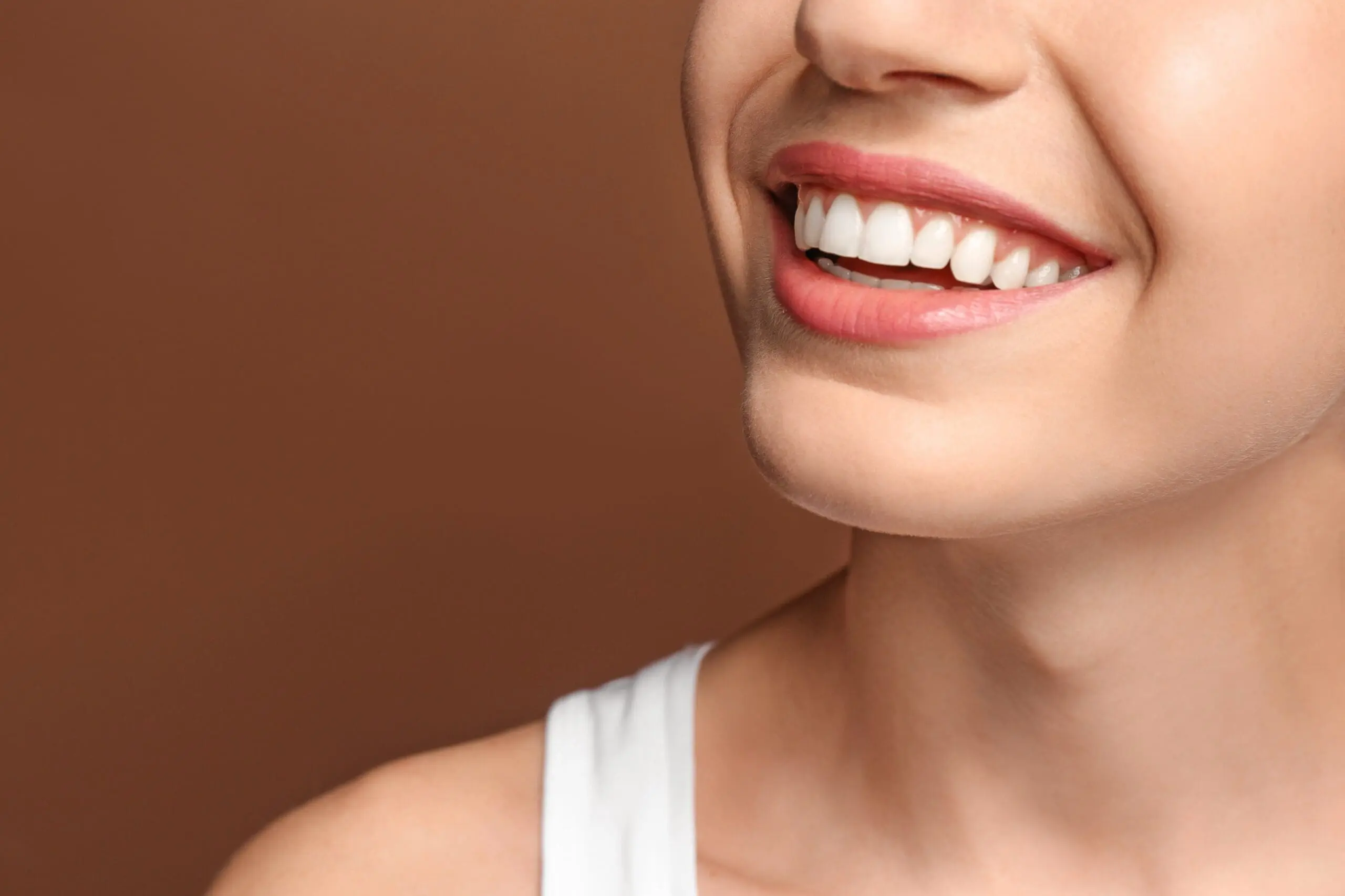 woman on a white sando smiling