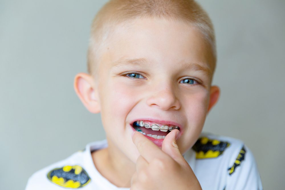 Portrait of a blond 8 year old boy with braces