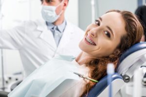 Selective focus of beautiful woman in braces during examination