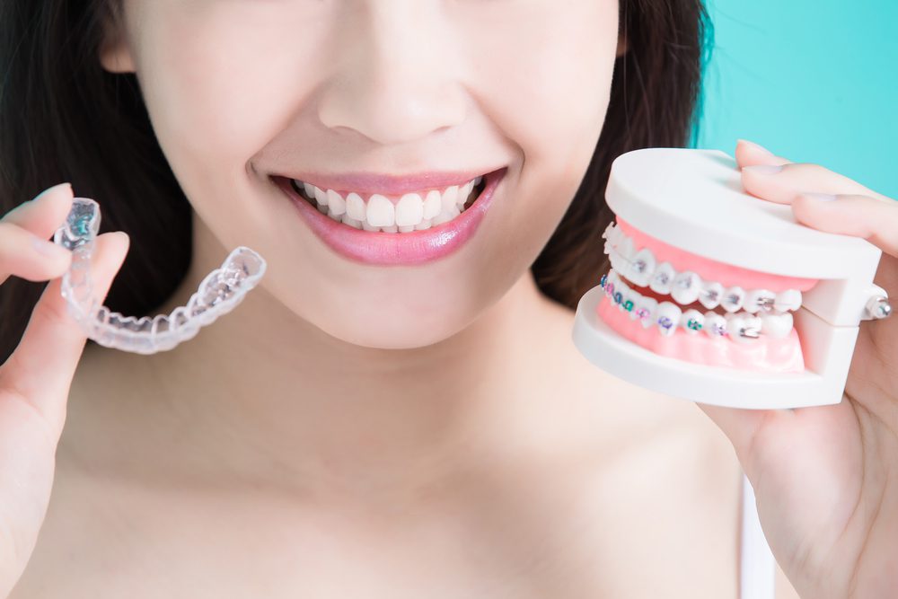 Woman making choices between braces and invisalign