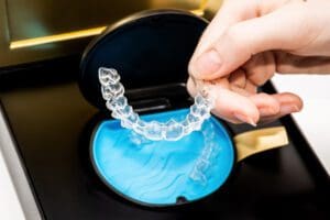 Transparent aligners in a box. Invisible braces. Clear teeth straighteners. Clear plastic bracers