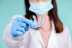 Asian dentists are teaching them how to care for oral and dental care, including after correct orthodontic treatment on blue background isolated studio shot.