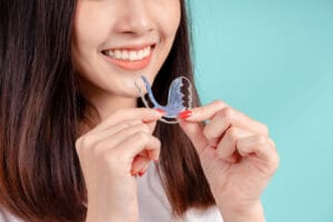 dental-of-asian-woman-with-tooth-sample-and-white-2023-11-27-05-18-07-utc