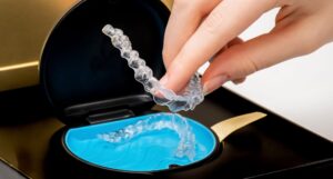 Transparent aligners in a box. Invisible braces. Clear teeth straighteners. Clear plastic bracers