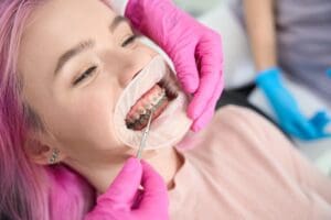 Orthodontist adjusting braces