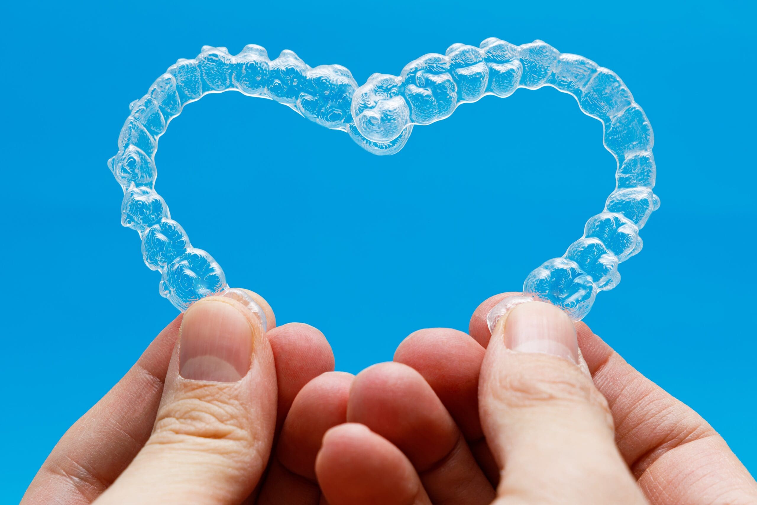 holding clear aligners in a heart shape